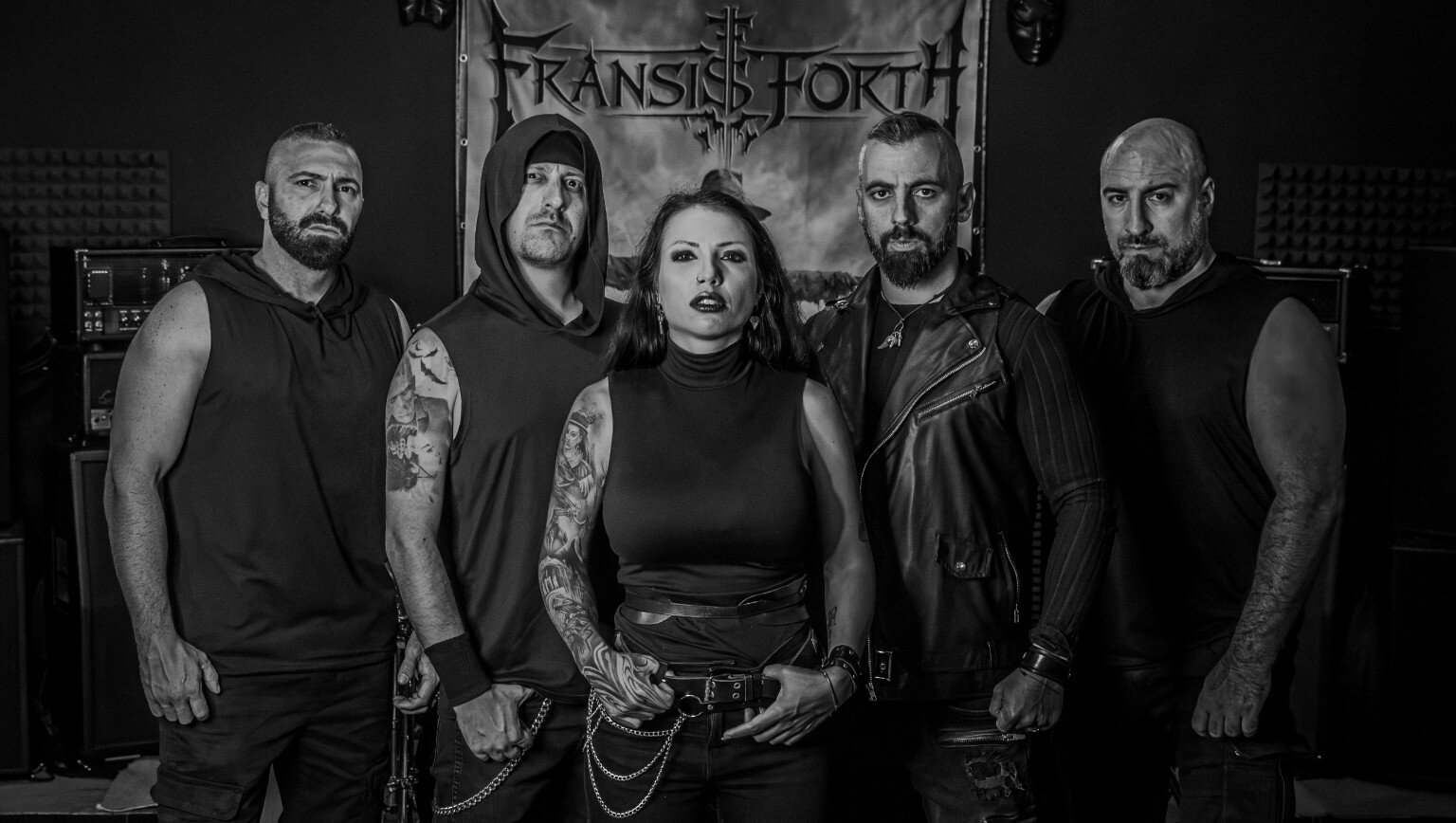 Fransis Forth band photo: the five members standing in front of the band's logo banner